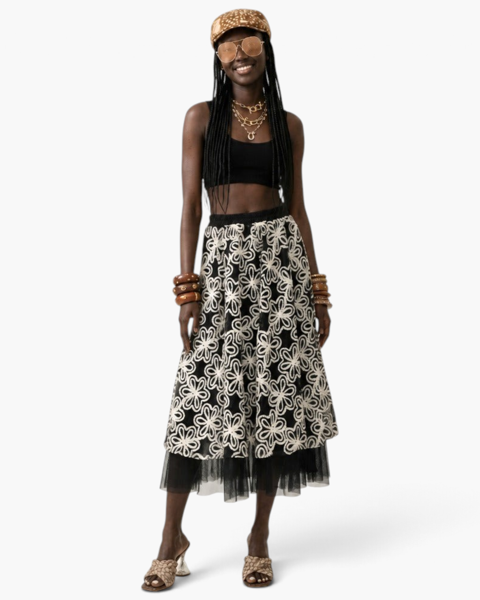 Beach Rose Co. black midi skirt with white floral embroidery and a sheer tulle hem worn by a model with accessories.
