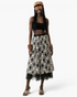 Beach Rose Co. black midi skirt with white floral embroidery and a sheer tulle hem worn by a model with accessories.