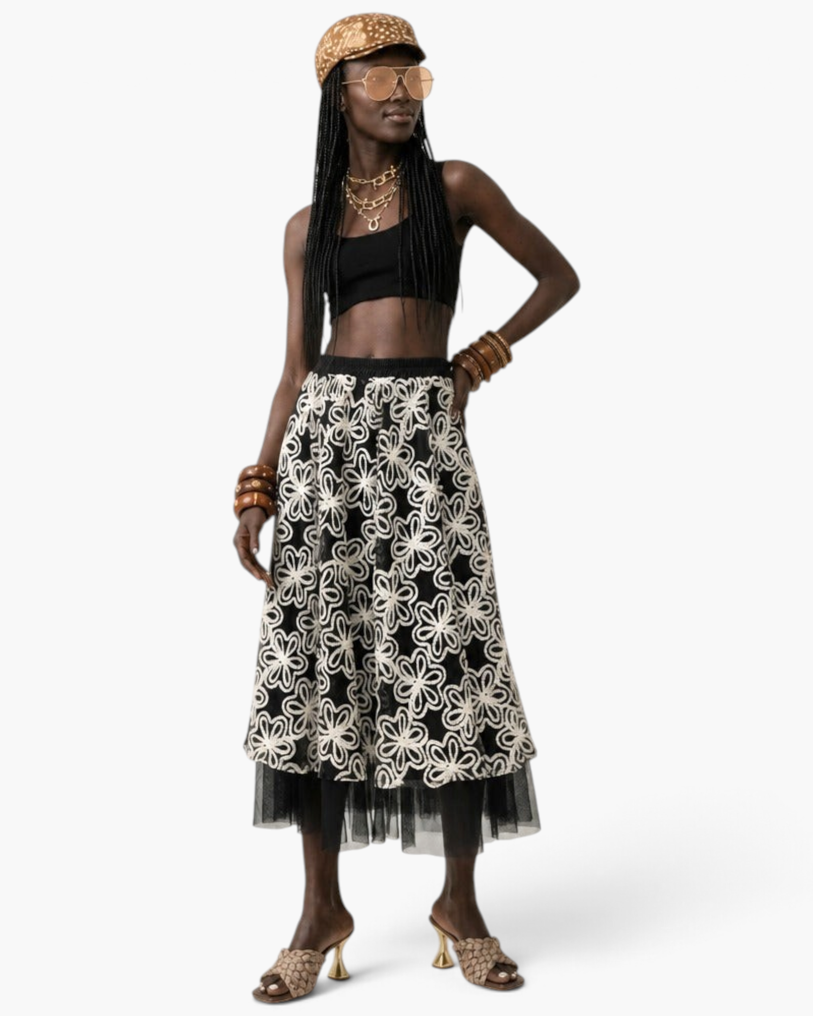 Beach Rose Co. midi skirt with white floral embroidery on black fabric and a sheer tulle hem worn by a model