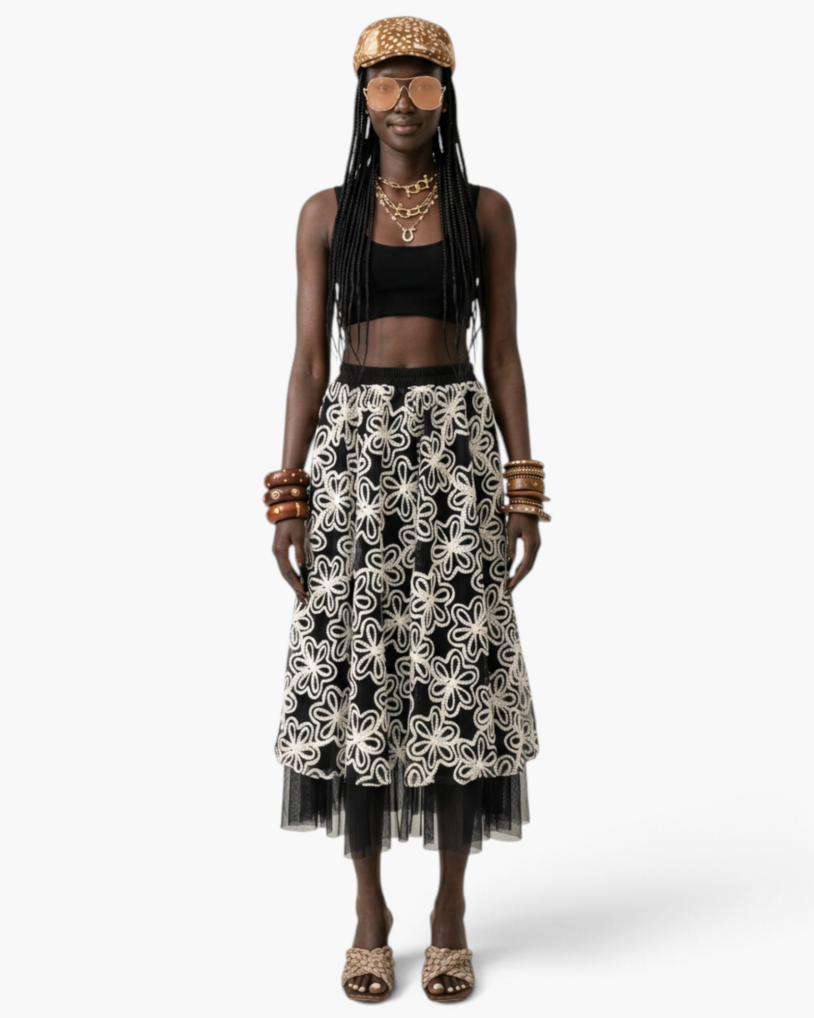 Beach Rose Co. midi skirt with white floral embroidery on black fabric and a sheer tulle hem worn by a model.