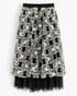 Beach Rose Co. black midi skirt featuring white floral embroidery and a sheer tulle hem with an elastic waistband.