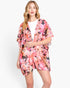 Beach Rose Co. floral print polyester cover-up with an open front, worn by a blonde model over a white top.