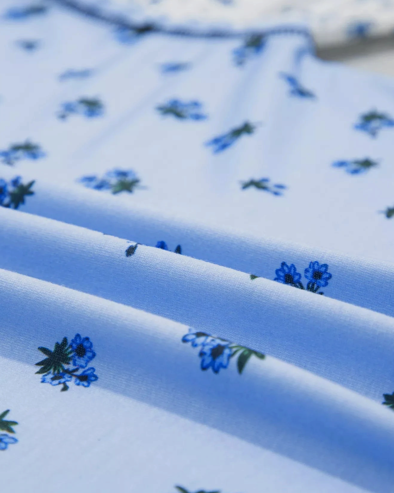 Beach Rose Co. light blue floral print long sleeve top in soft, slightly stretchy polyester blend fabric.