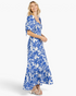 Beach Rose Co. royal blue and white floral cotton maxi dress with puff sleeves and a ruffled hem on a smiling model