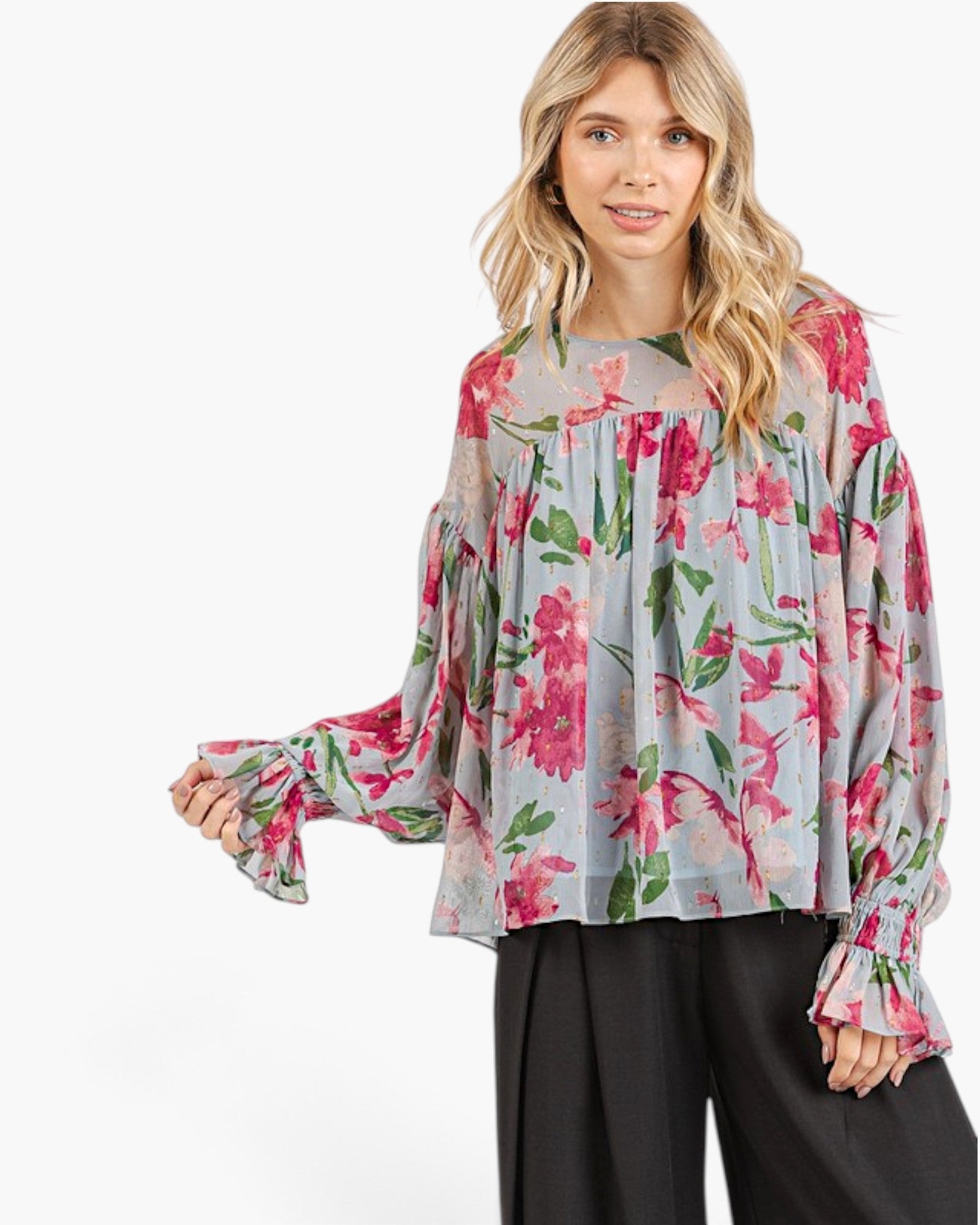 Beach Rose Co. light blue blouse with pink floral print, balloon sleeves, and smocked ruffle cuffs on a model