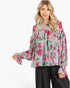Beach Rose Co. light blue blouse with pink floral print, balloon sleeves, and smocked ruffle cuffs on a model