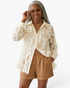 Beach Rose Co. cream sheer button-up blouse featuring dimensional floral appliqués and sequin details on a model.