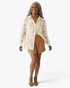 Beach Rose Co. cream sheer button-up blouse with dimensional floral appliqués and sequins worn by a smiling woman.