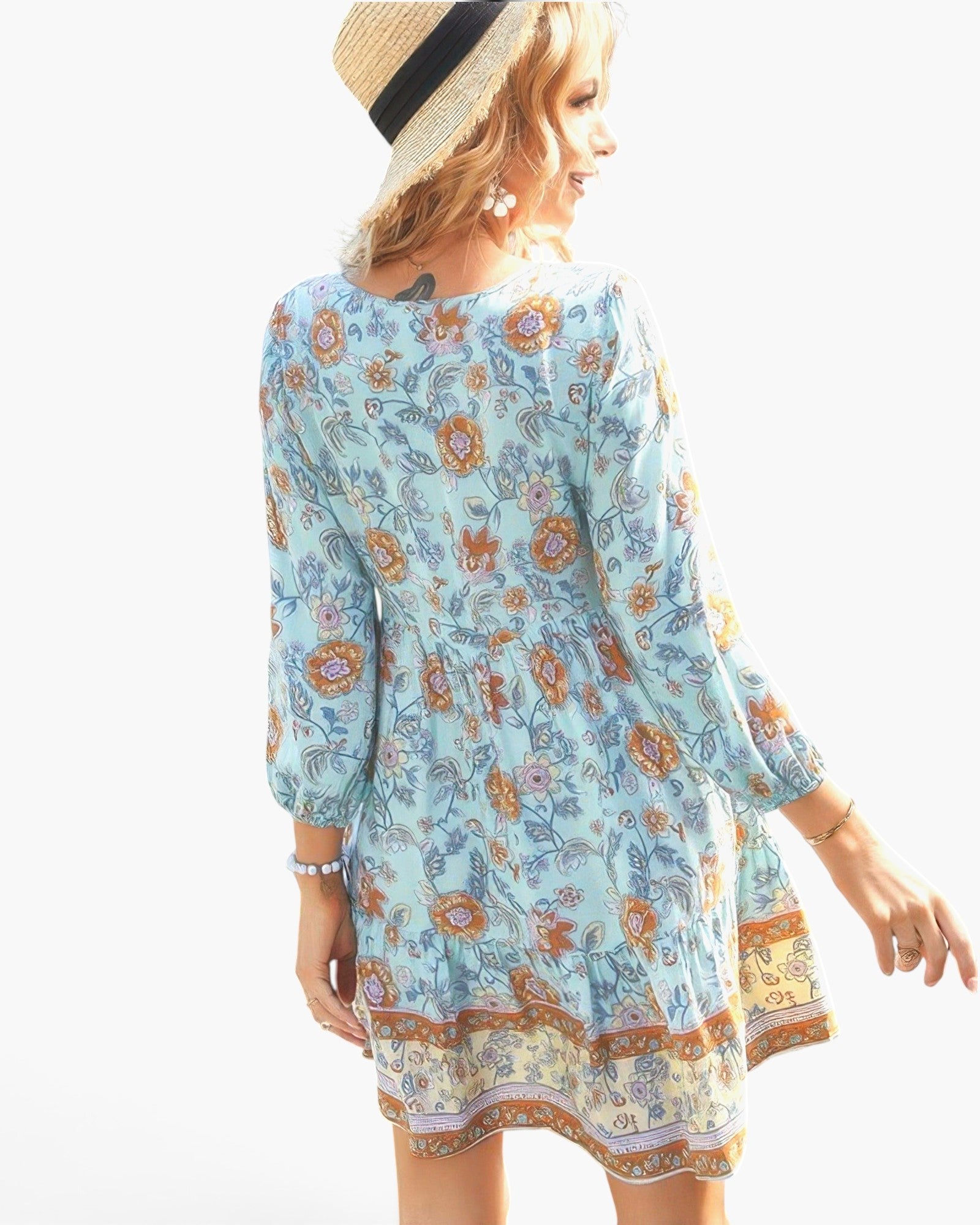 Beach Rose Co. light blue floral viscose dress with long sleeves, V-neck, and straw hat on a model, back view