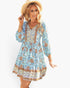 Beach Rose Co. light blue floral viscose dress with V-neck, button front, and long sleeves worn with a straw hat.