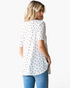 Beach Rose Co. white textured waffle knit tunic with a colorful ditsy floral print and a curved hem, back view.