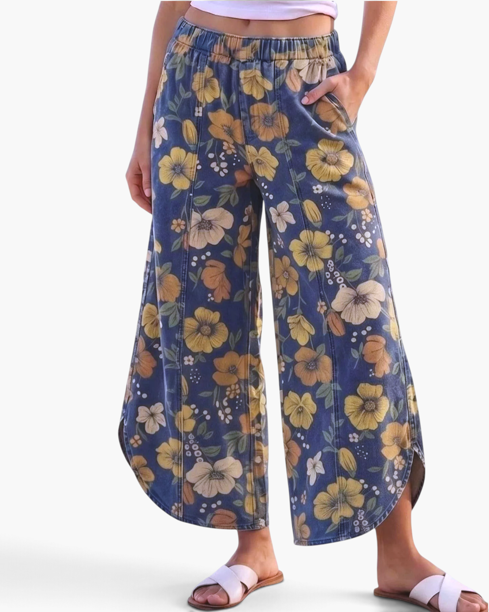 Beach Rose Co. blue wide leg pants featuring a yellow and orange floral print, elastic waist, and curved side slits.