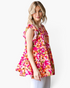 Beach Rose Co. fuchsia floral tiered top with flutter sleeves and a relaxed fit worn by a blonde model