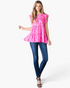 Beach Rose Co. fuchsia leopard print tiered top with flutter sleeves and round neckline worn with blue skinny jeans