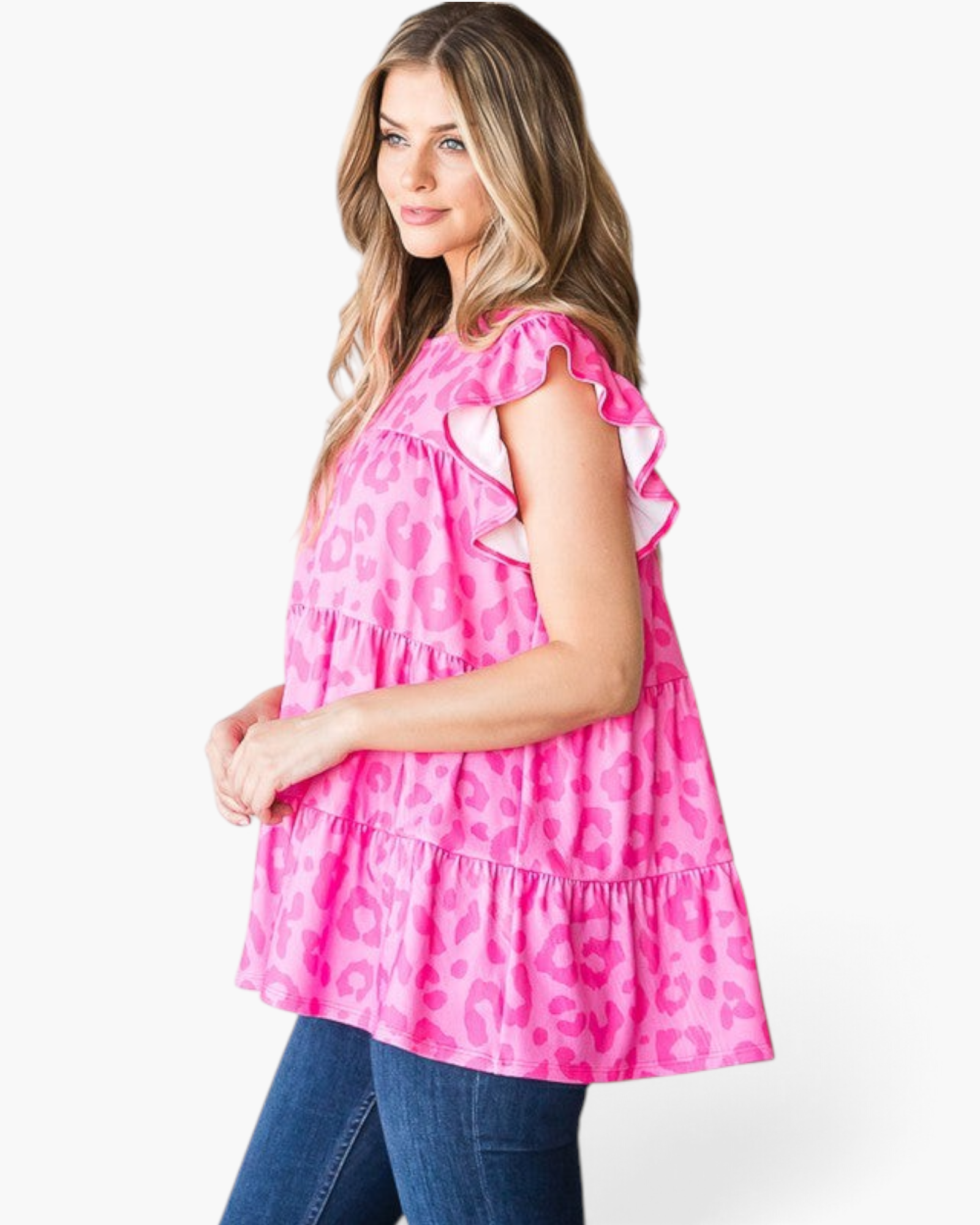 Beach Rose Co. fuchsia leopard print tiered top with flutter sleeves and a round neckline worn with blue jeans