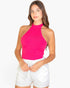 Beach Rose Co. fuchsia ribbed halter neck backless crop top worn by a woman with long brown hair.