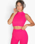 Beach Rose Co. fuchsia ribbed mock neck crop tank top and matching pants worn by a woman with headphones.