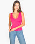 Beach Rose Co. fuchsia ribbed V-neck sleeveless top worn by a woman with blue jeans against a white background