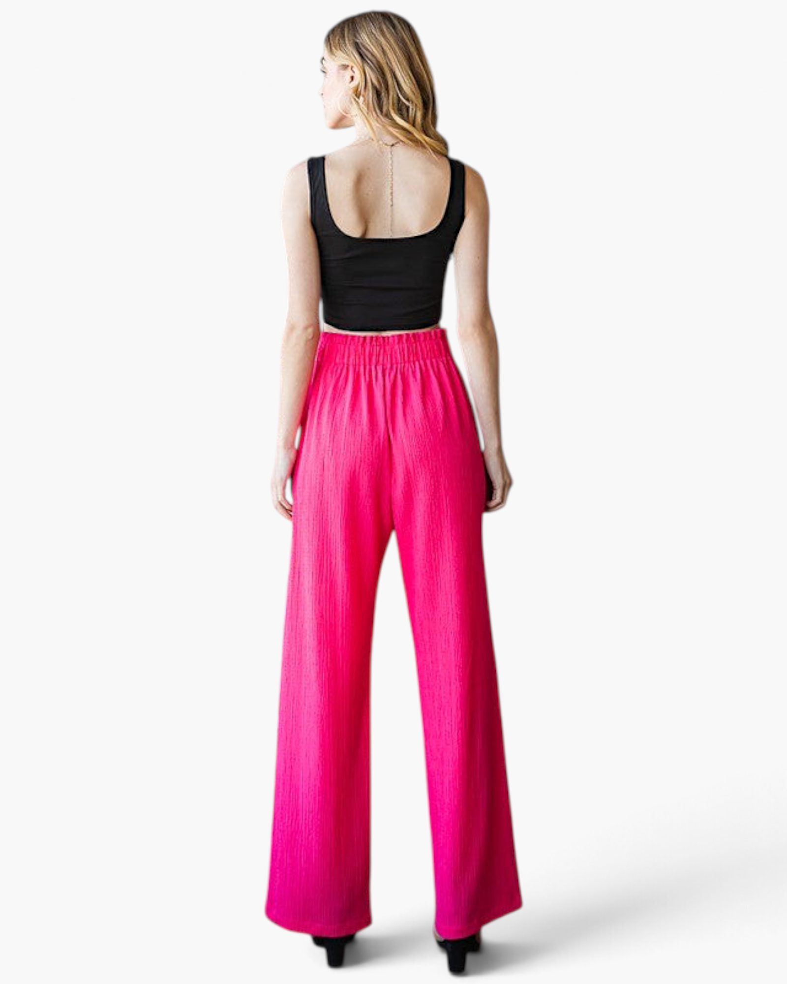 Beach Rose Co. fuchsia wide-leg pants with a ruffled elastic waistband and textured fabric, back view.