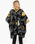 Beach Rose Co. fuzzy Aztec open-front ruana with a black, yellow, and white geometric pattern and textured trim.