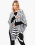 Beach Rose Co. fuzzy chevron pattern ruana in black and white worn over a black top for a stylish layered look.