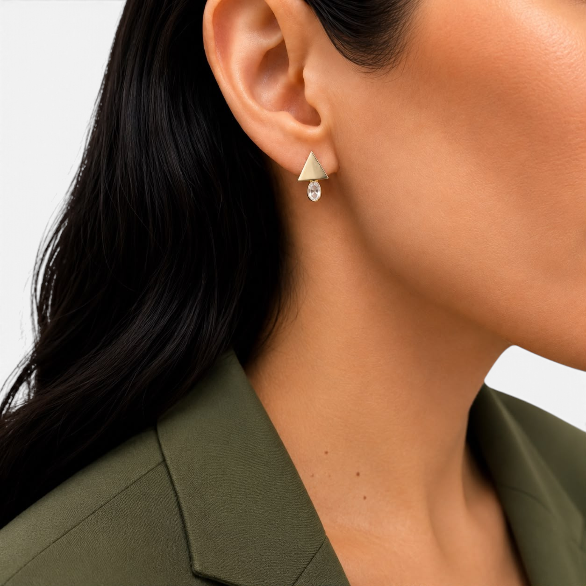 Beach Rose Co. geometric stud earrings featuring a gold triangle above an oval cubic zirconia stone on a model