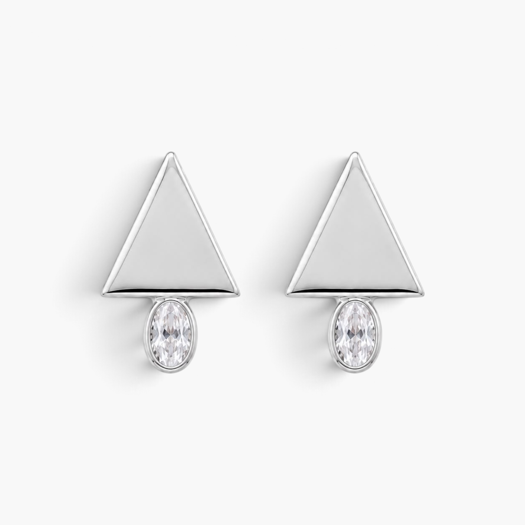 Beach Rose Co. geometric stud earrings featuring a polished silver triangle above an oval cubic zirconia stone.