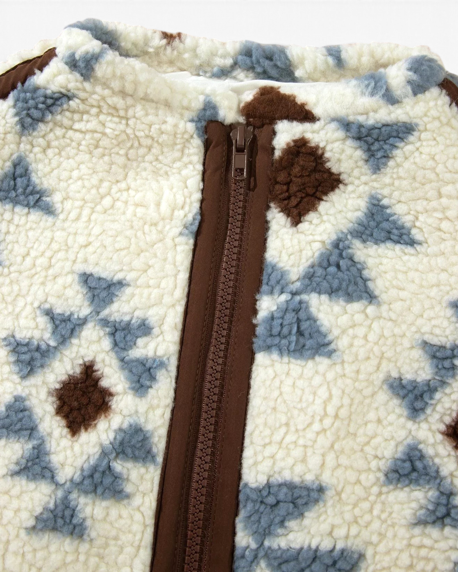Beach Rose Co. cream sherpa pullover with blue and brown geometric patterns and a brown half-zip neckline detail.