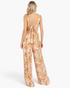 Back view of a Beach Rose Co. ginger floral wide-leg jumpsuit with a smocked waist and back tie detail.
