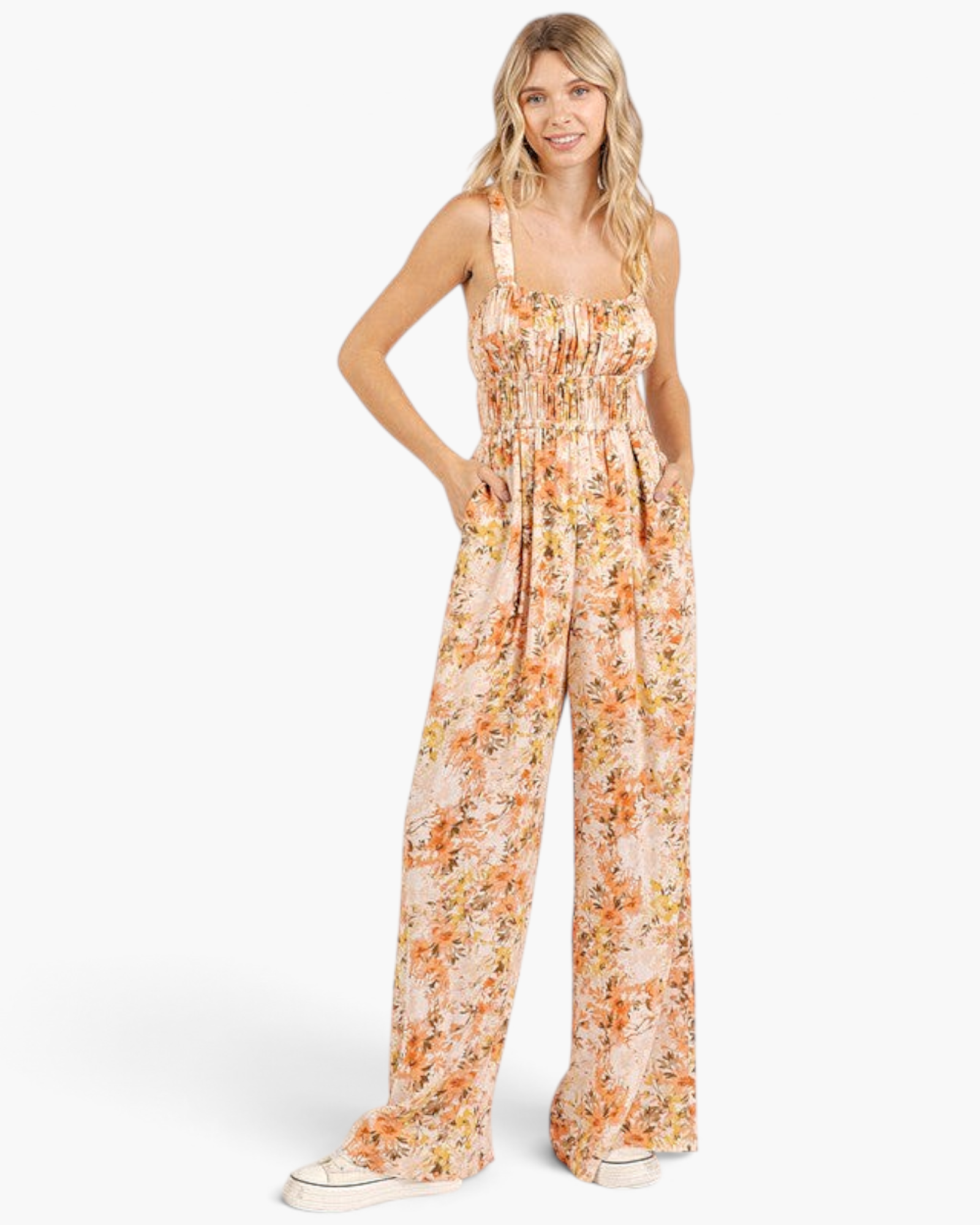 Beach Rose Co. ginger floral wide-leg jumpsuit with a smocked waist, gathered bodice, and pockets on a blonde model.
