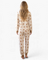 Beach Rose Co. cream gingerbread print pajama set with long sleeves and joggers, back view on a blonde model.