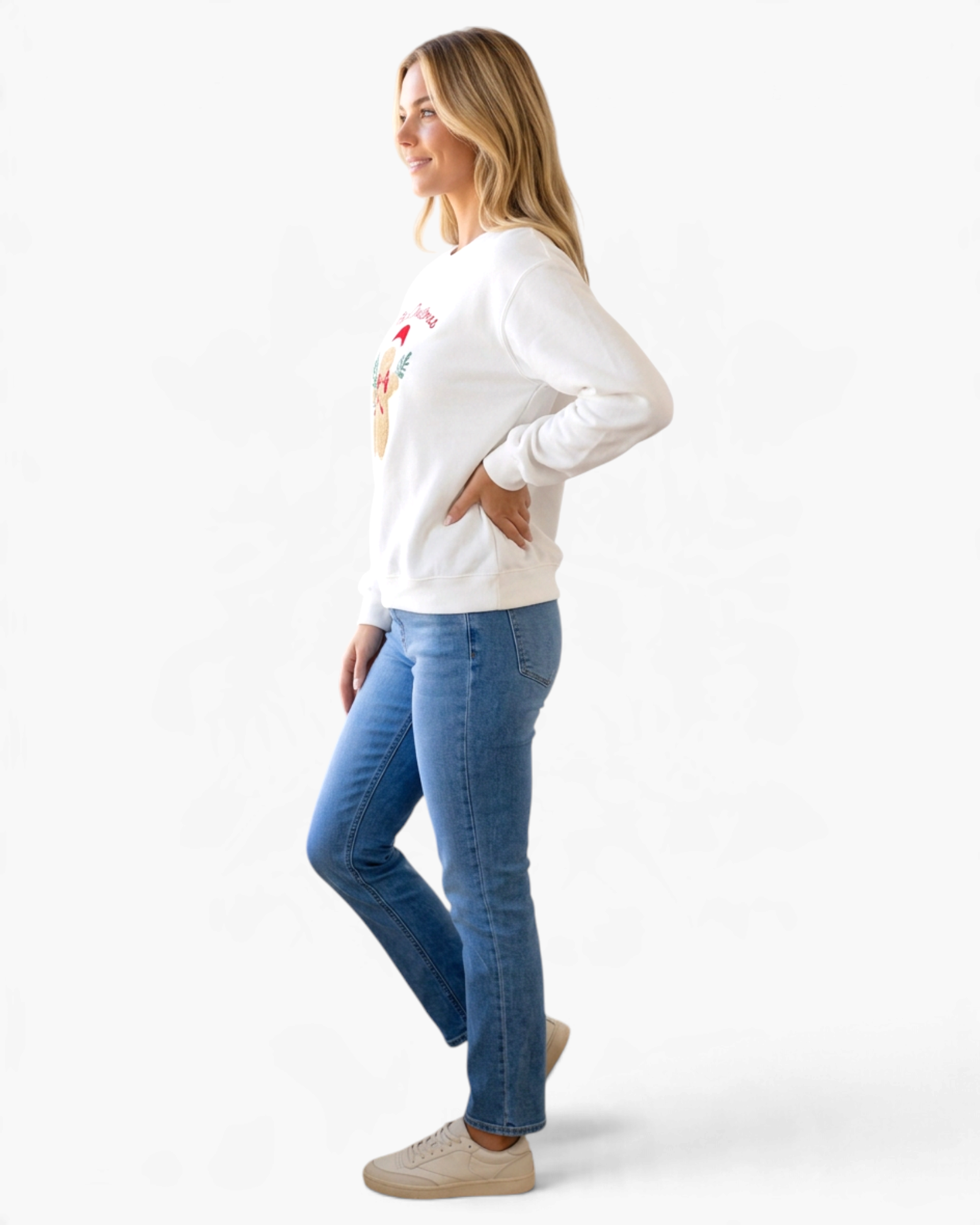 Beach Rose Co. white crewneck sweatshirt with gingerbread appliqué, worn by a model with blue jeans and sneakers.