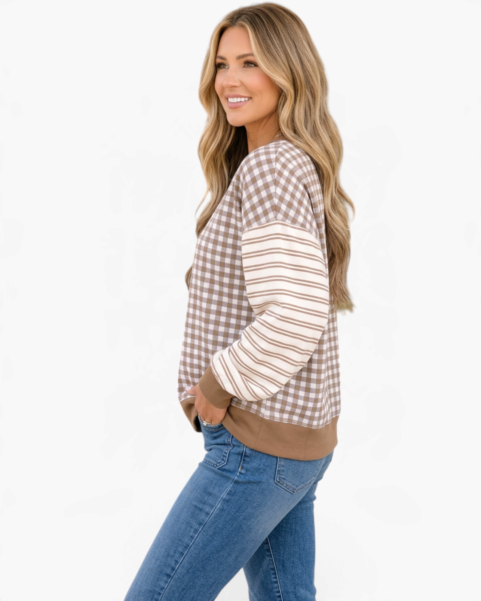 Beach Rose Co. taupe and cream gingham sweatshirt with striped sleeves and ribbed trim worn by a smiling woman