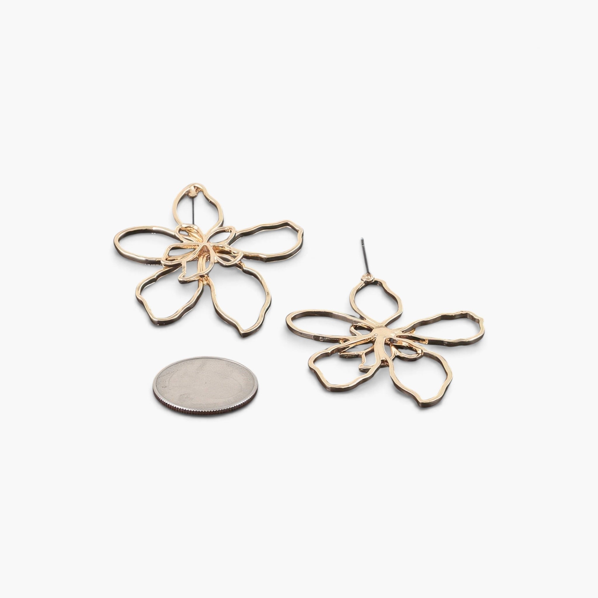 Beach Rose Co. gold-tone abstract flower earrings with delicate wire detailing shown next to a coin for scale.
