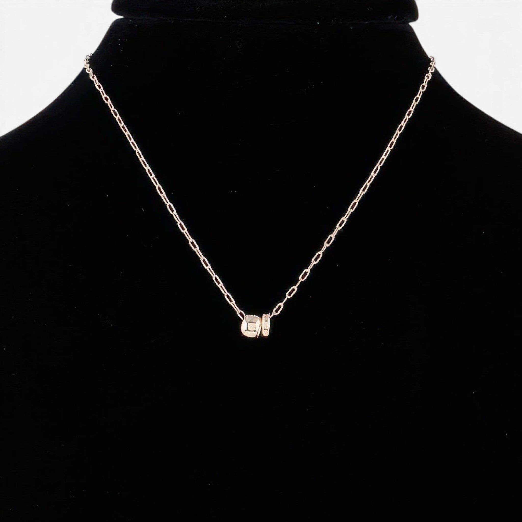 Beach Rose Co. gold chain necklace featuring a delicate ball charm on a black display bust