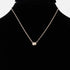 Beach Rose Co. gold chain necklace featuring a delicate ball charm on a black display bust