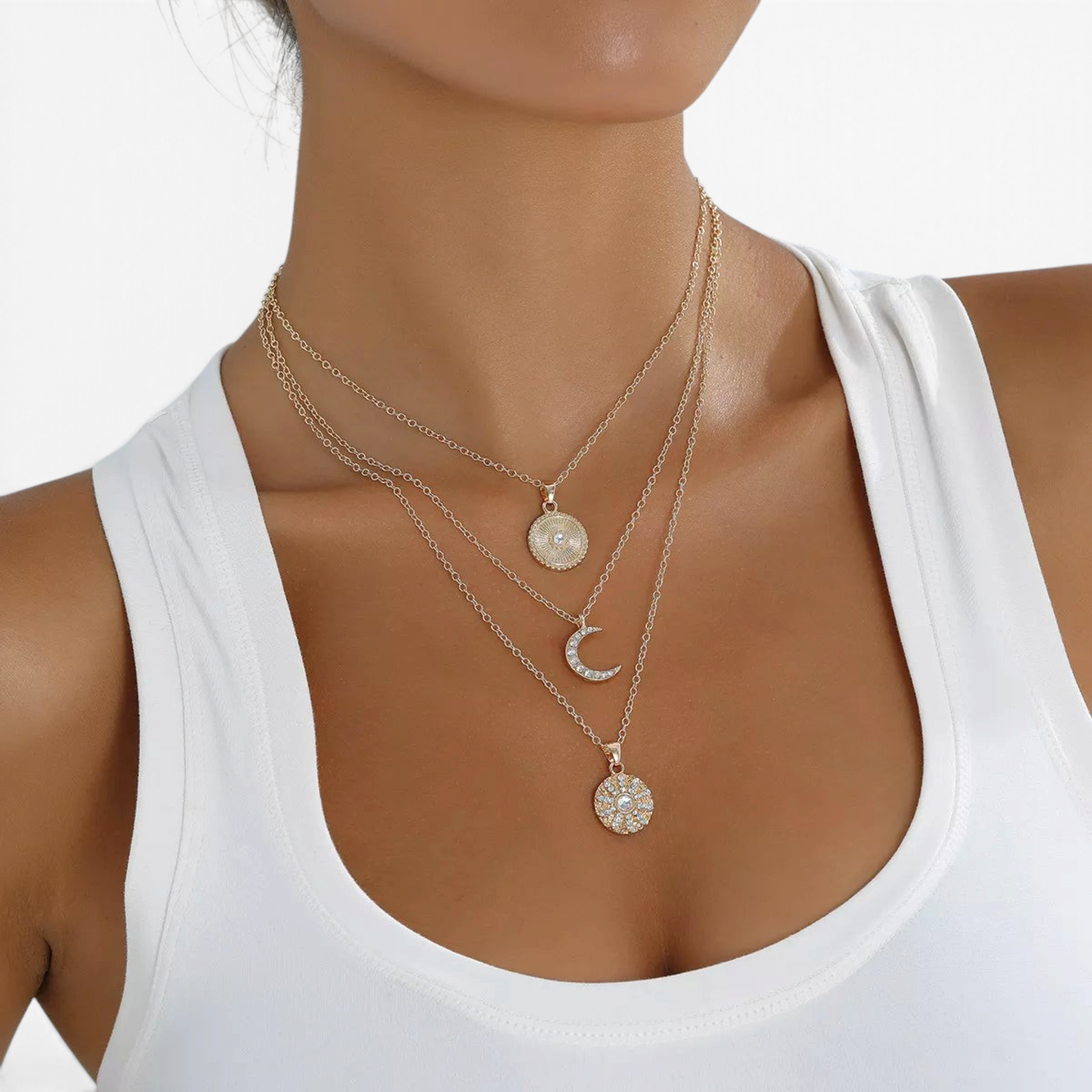 Beach Rose Co. 18K gold-plated layered necklace featuring sunburst, crescent moon, and zircon-accented pendants.