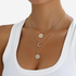 Beach Rose Co. 18K gold-plated layered necklace featuring sunburst, crescent moon, and zircon-accented round pendants.