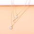 Beach Rose Co. 18K gold-plated layered necklace featuring sunburst, crescent moon, and zircon-accented pendants.