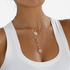 Beach Rose Co. 18K gold-plated layered necklace featuring sunburst, crescent moon, and zircon-accented pendants.
