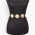Beach Rose Co. gold metal chain belt featuring ornate circular medallions on a black mannequin torso