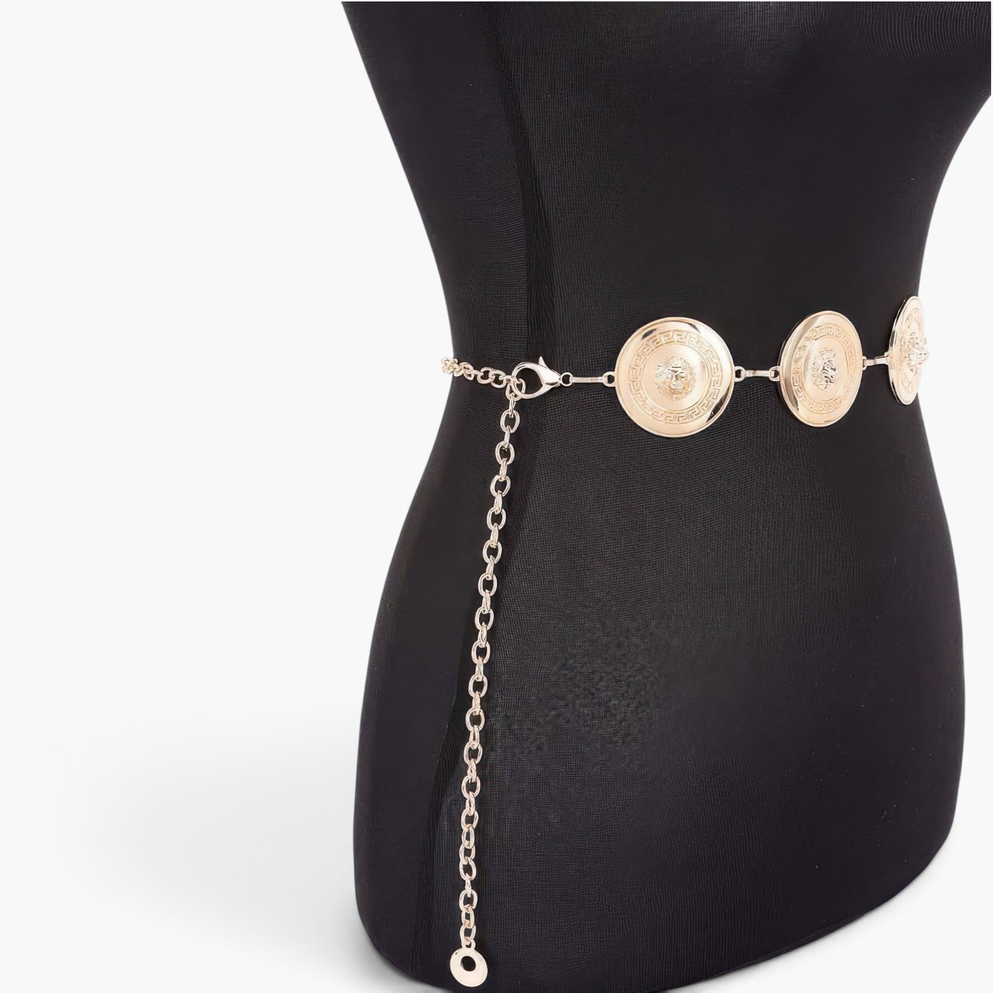 Beach Rose Co. gold metal chain belt featuring circular medallions with embossed lion heads on a black mannequin torso.