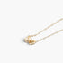Beach Rose Co. gold chain necklace featuring two delicate interlocking ball charms on a simple link chain.
