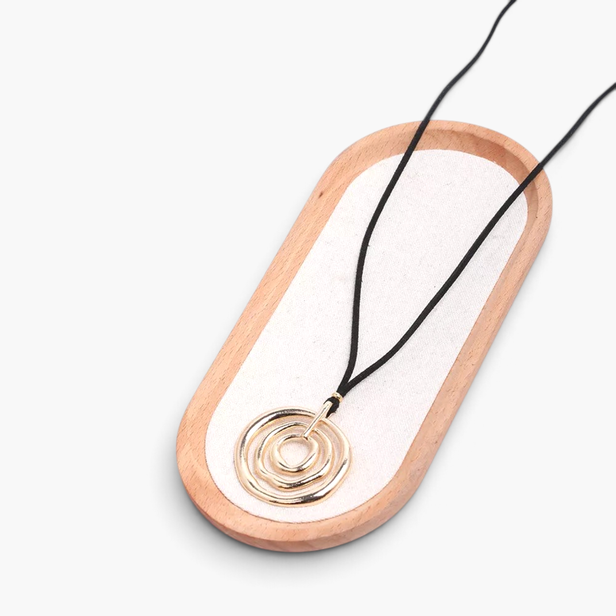Beach Rose Co. long necklace featuring a black PU cord and an 18K gold-plated pendant with nested organic circles.