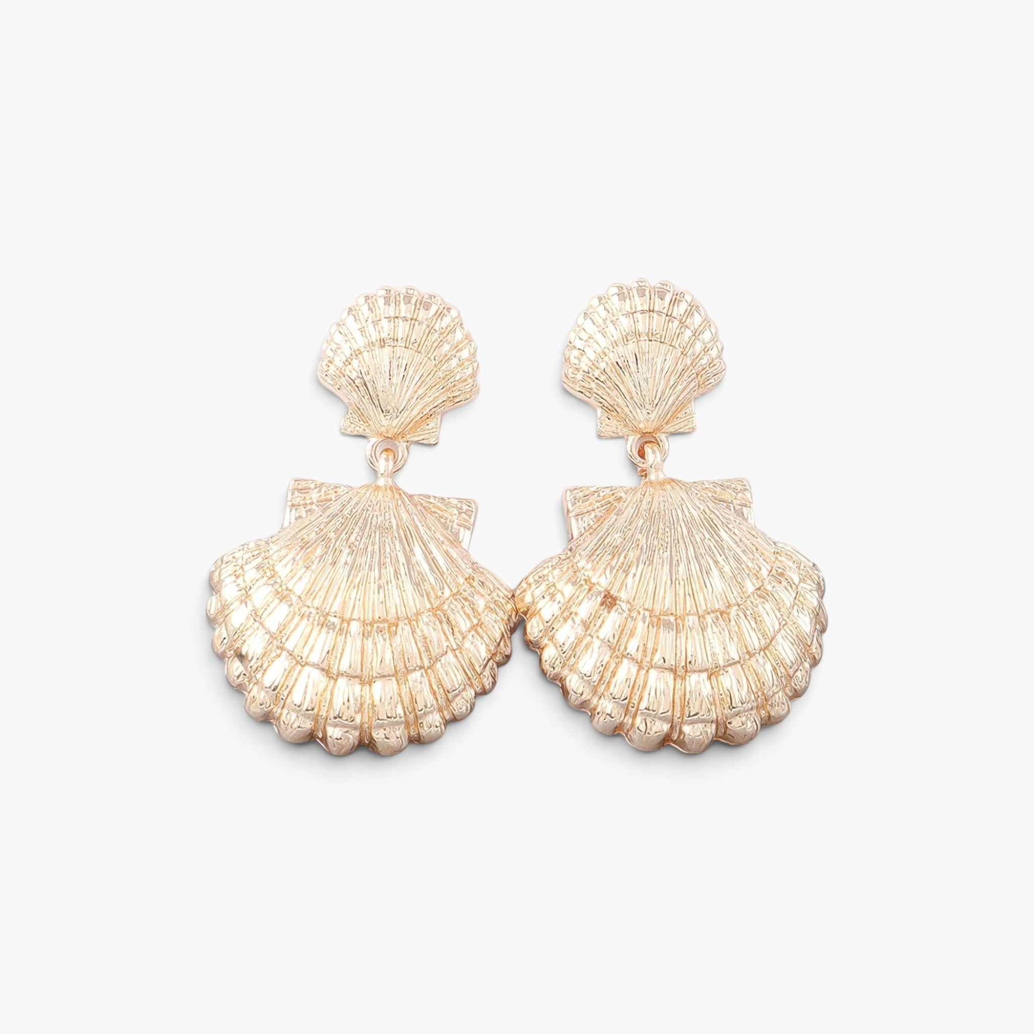 Beach Rose Co. gold double clamshell drop earrings with intricate textured shell details on a white background.