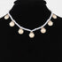Beach Rose Co. gold clamshell charm necklace with white pearls on a black display bust
