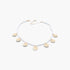 Beach Rose Co. gold clamshell charm necklace featuring a delicate strand of white pearls on a light background.