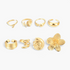 Beach Rose Co. eight-piece 18K gold-plated ring set featuring coastal shell, starfish, and flower designs.