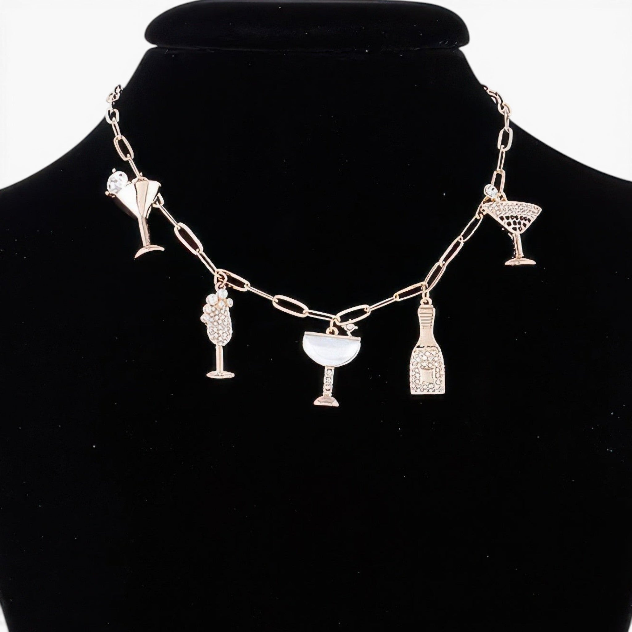 Beach Rose Co. gold chain necklace featuring whimsical party drink charms with sparkling clear jewels on a black bust