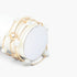 Beach Rose Co. gold and cream beaded wrap bracelet featuring delicate heart charms on a white display stand